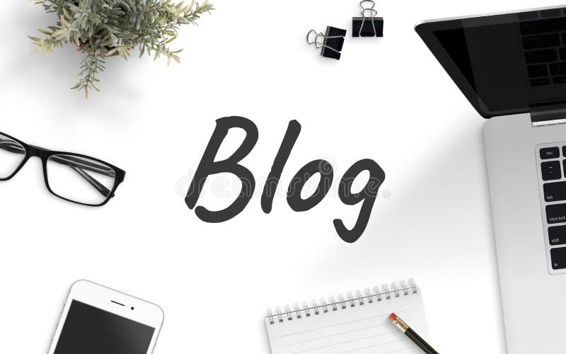 A white surface with the word "Blog" written in large, dark gray cursive letters. Surrounding the word are a laptop computer, a smartphone, eyeglasses, a small potted plant, two binder clips, and a spiral notebook with a pencil on top.