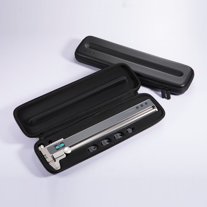 The image shows a digital caliper and its carrying case. The caliper is silver with a digital display and is placed inside a black, hard-shell case with a zippered closure. The case has a foam insert that snugly fits the caliper, ensuring it is secure during transport. The caliper has a long, straight body with a digital readout and a sliding mechanism for precise measurements. There are also several interchangeable anvil tips visible, which are used for different measurement tasks. The case is designed to protect the caliper from damage and is portable, making it convenient for fieldwork or travel.